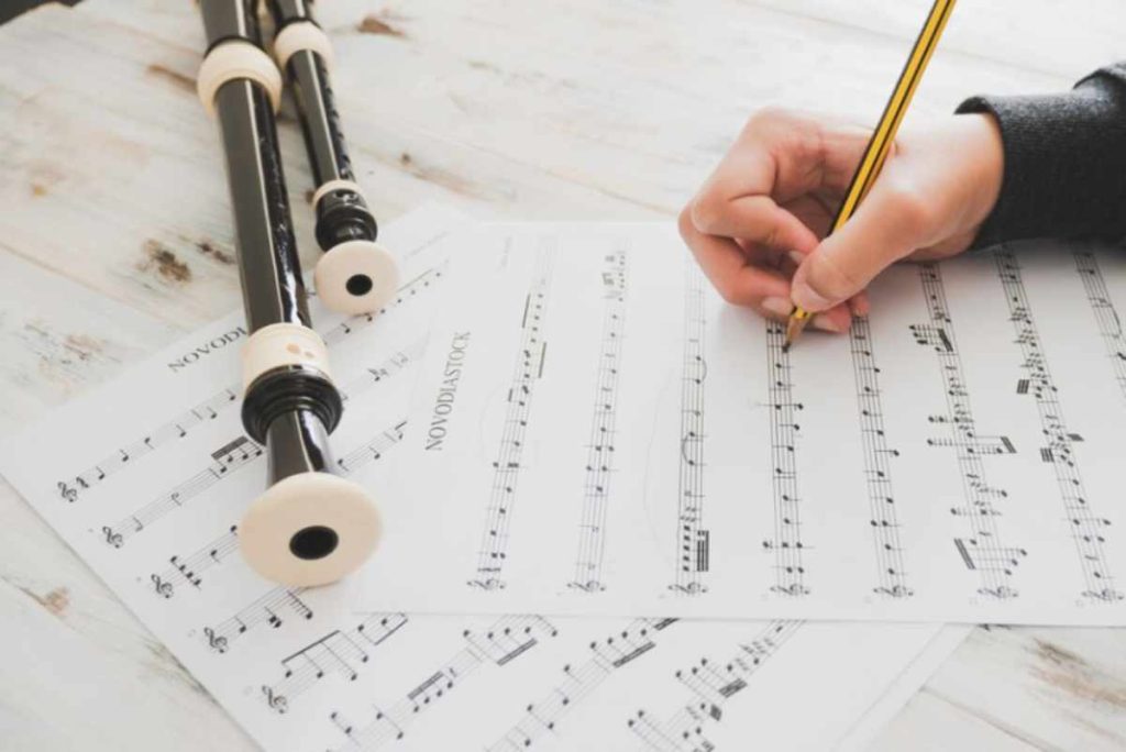 Musician reading Classical Music Lead Sheets and playing a simplified version of a classical piece on piano, focusing on melody and chord symbols for an easy performance.