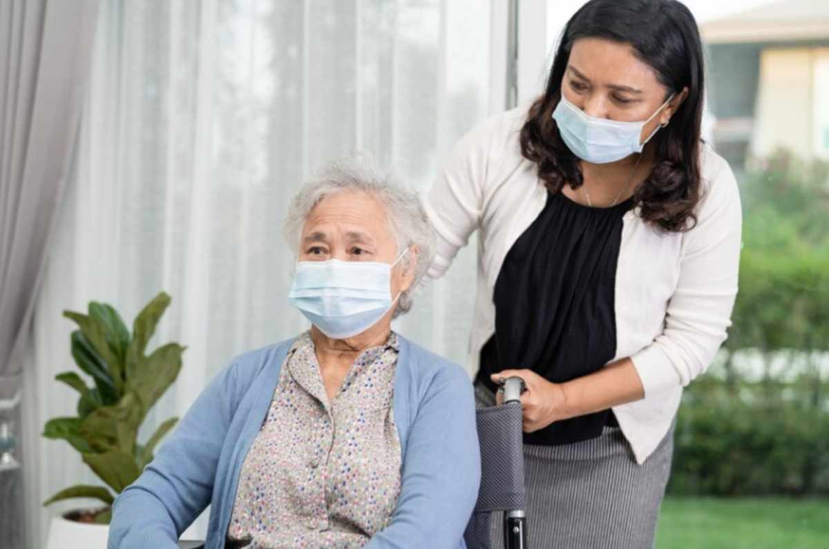 An elderly person reviewing financial options and documents, exploring how to pay for nursing home care with Social Security benefits, while considering additional support options like Medicaid.
