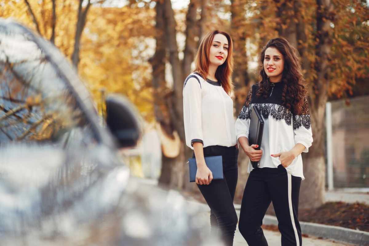 An opulent living room with stylish, modern furniture, marble floors, and large windows offering a stunning city view.