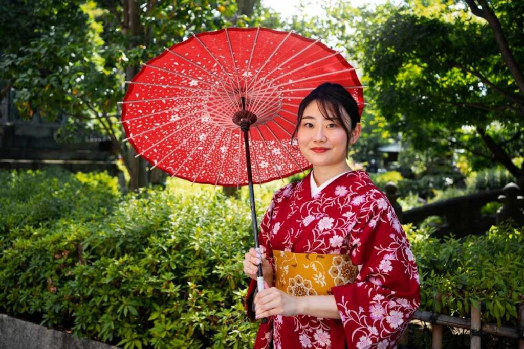 A model wearing a lightweight black kimono over a tank top, perfect for staying cool and stylish in hot weather.