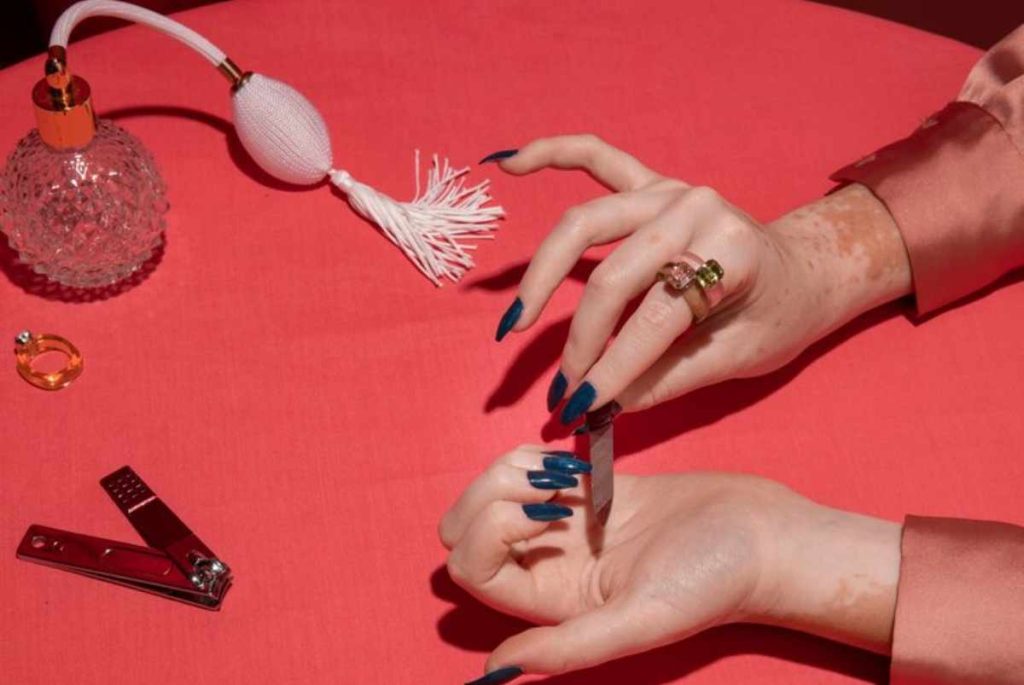 Close-up of hands with minimal nail art featuring micro French tips and milky white polish, perfect for a clean and modern style.