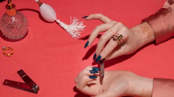 Close-up of hands with minimal nail art featuring micro French tips and milky white polish, perfect for a clean and modern style.