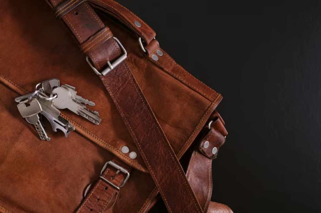 "Person wiping leather furniture with a premium leather cleaning wipe."