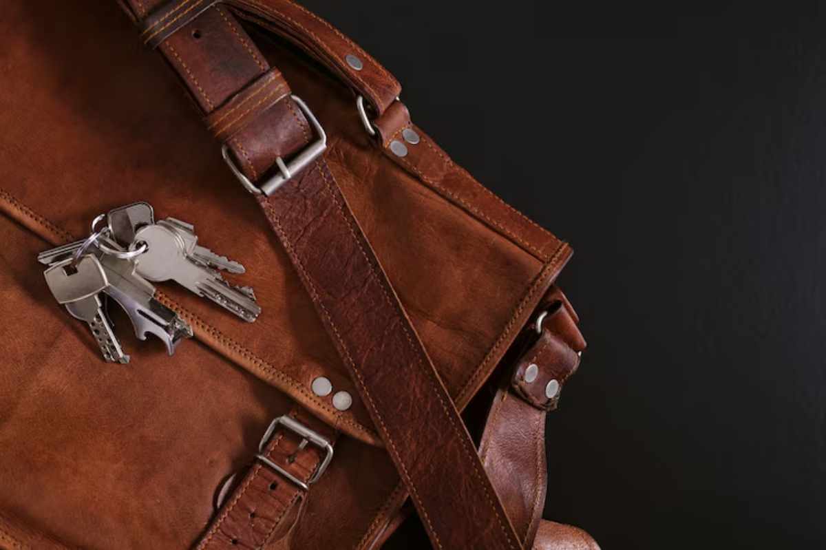 "Person wiping leather furniture with a premium leather cleaning wipe."
