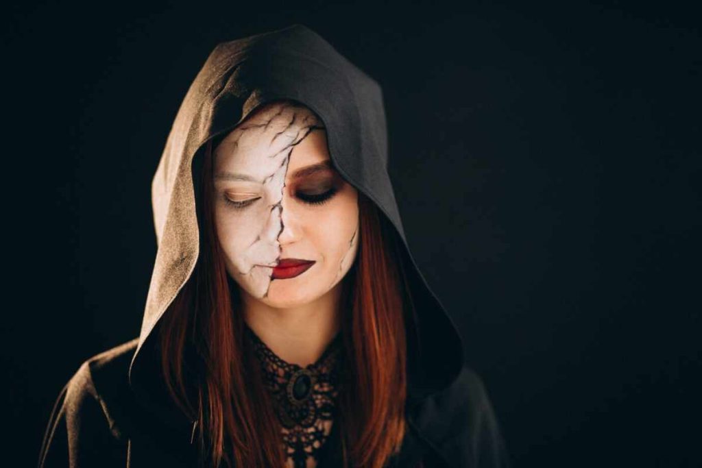 "Model wearing bold and daring glam makeup with smoky eyes and red lips"