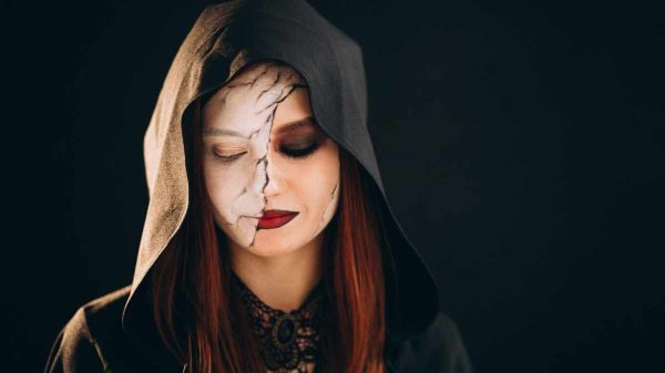 "Model wearing bold and daring glam makeup with smoky eyes and red lips"