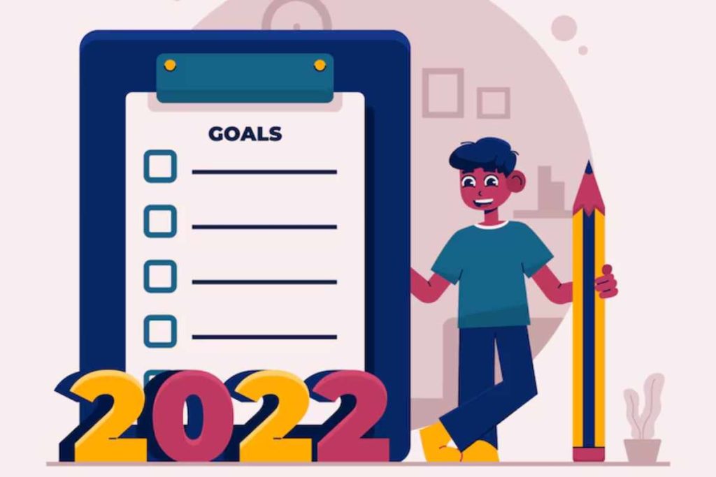 "Person writing 2025 goals in a planner with a pen"