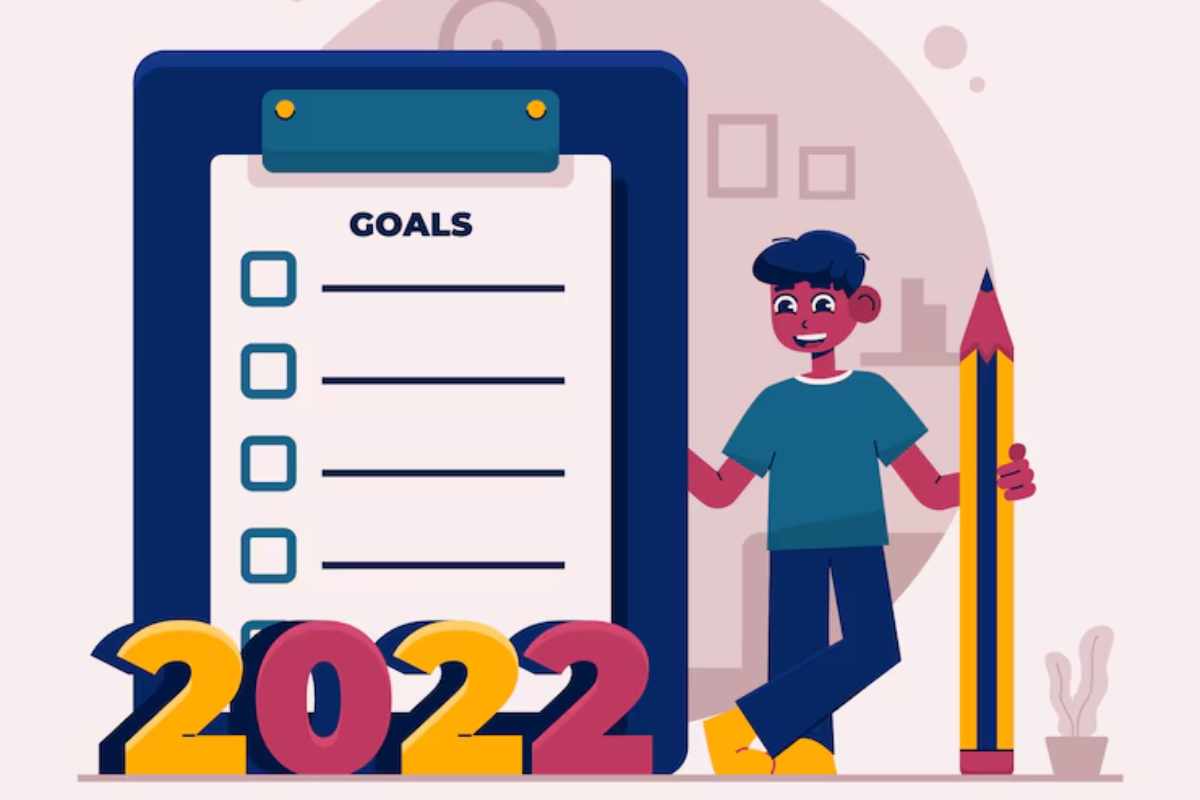 "Person writing 2025 goals in a planner with a pen"