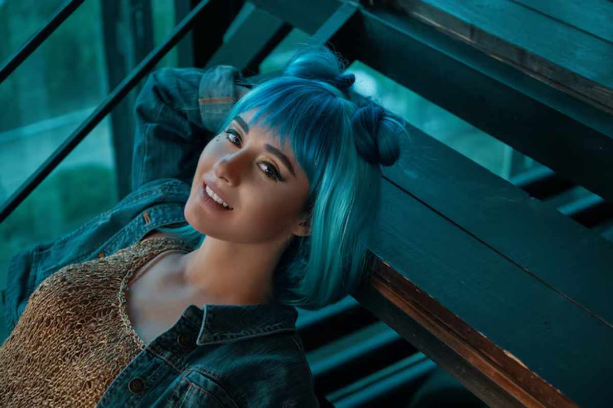 A variety of blue hair dye shades displayed on hair swatches, showcasing pastel blue, electric blue, navy blue, and teal options for different hair styles.