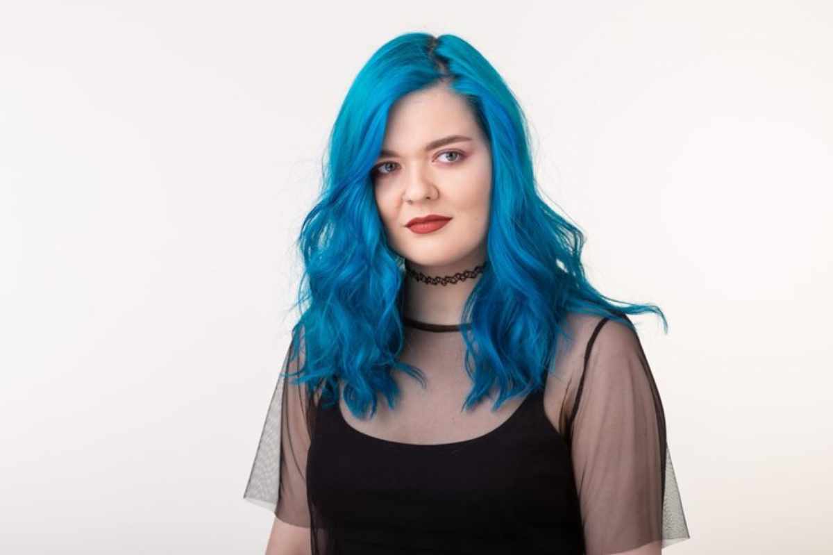 A variety of blue hair dye shades displayed on hair swatches, showcasing pastel blue, electric blue, navy blue, and teal options for different hair styles.