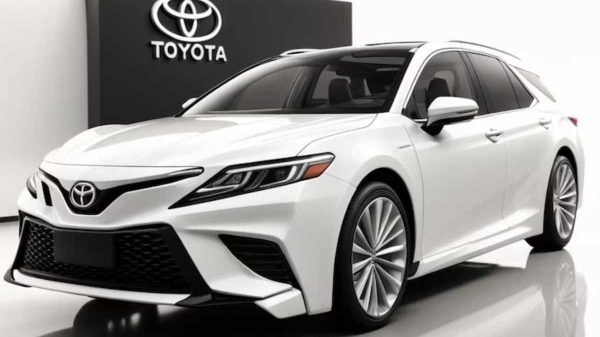 "A used Toyota Corolla parked outside a dealership with a sale sign"